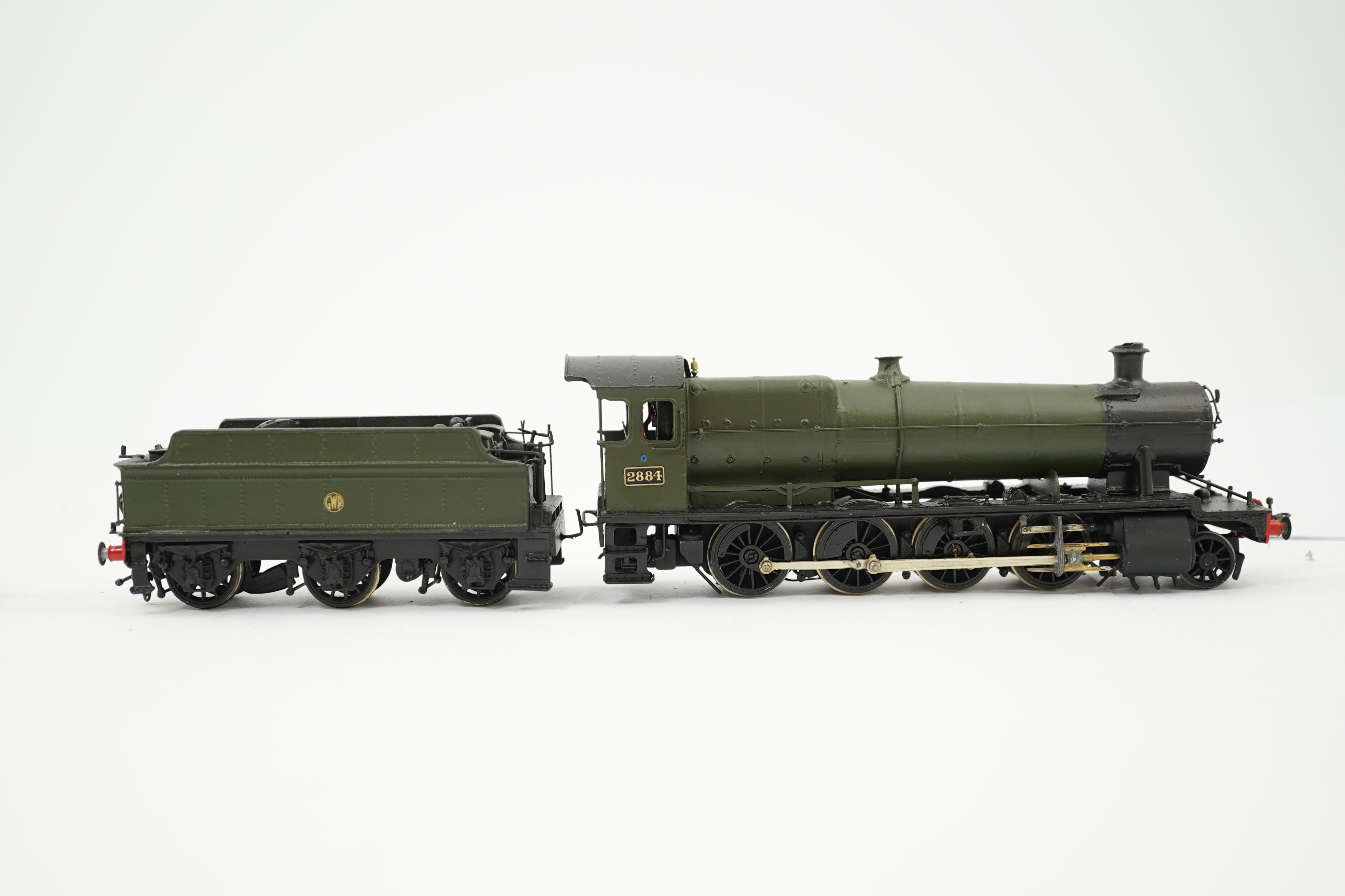 Three 00 gauge brass and white metal kit built GWR tender locomotives; a 2884 class 2-8-0, 2884, together with an 33xx class 4-4-0, 3454, and a War Dept. 2-8-0, 3012, all constructed, painted and lined to a high standard